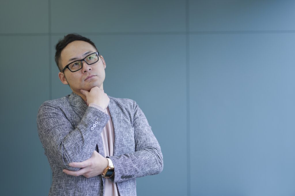 顎に手を当てる男性